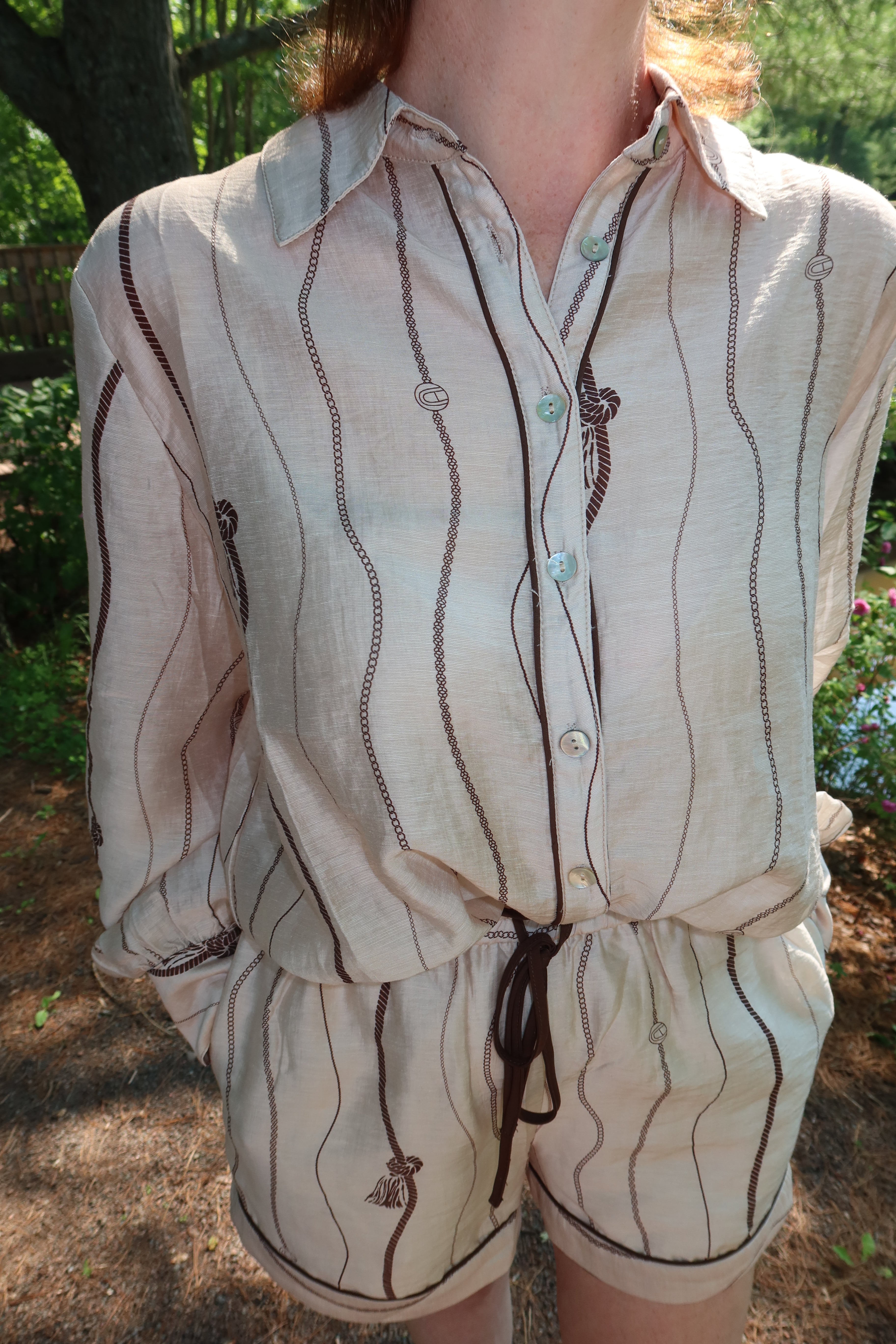 Woman wearing the Portofino matching blouse and shorts set in taupe
