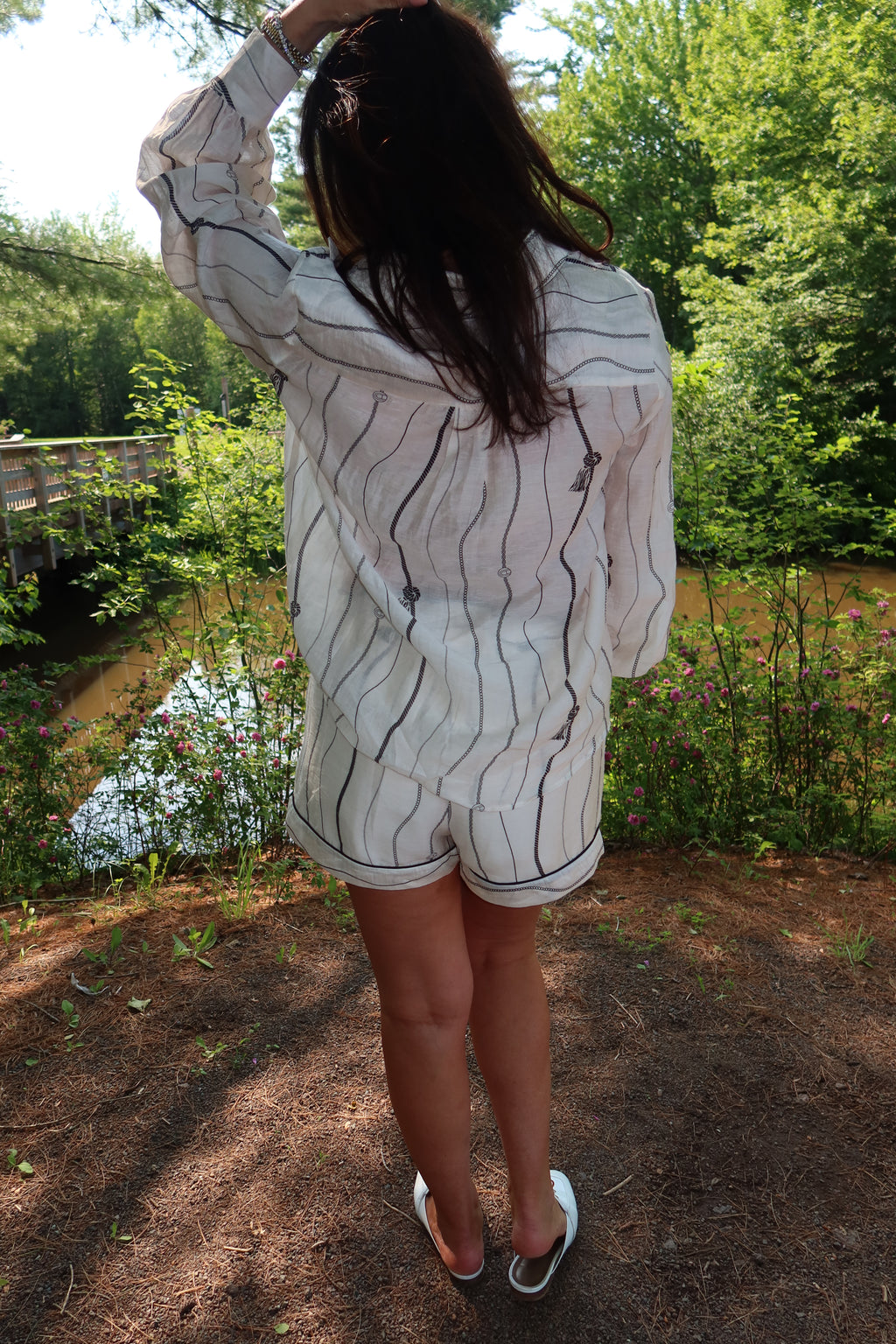 Woman wearing the Portofino matching blouse and shorts set in Cream