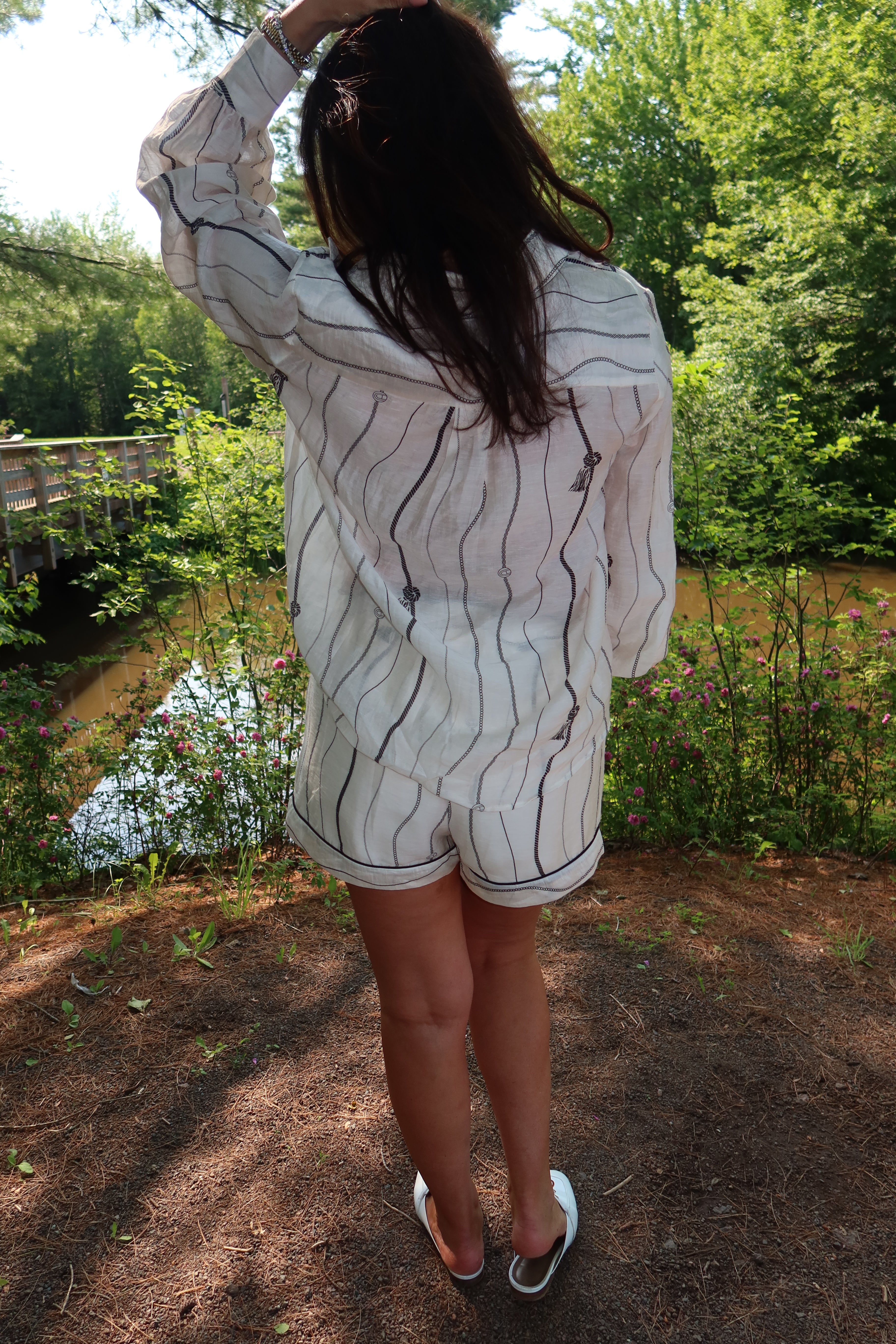 Woman wearing the Portofino matching blouse and shorts set in Cream