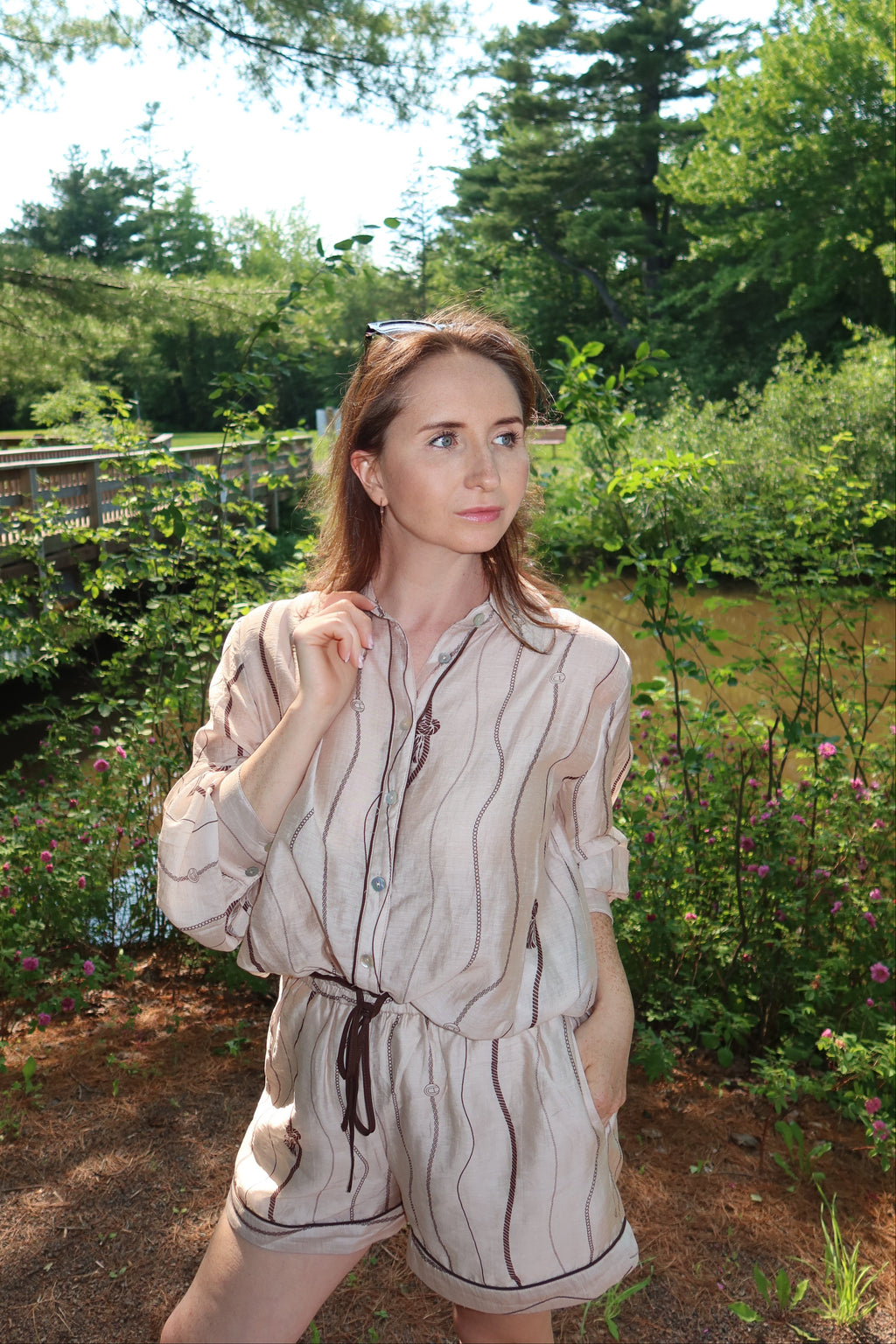 Woman wearing the Portofino matching blouse and shorts set in taupe