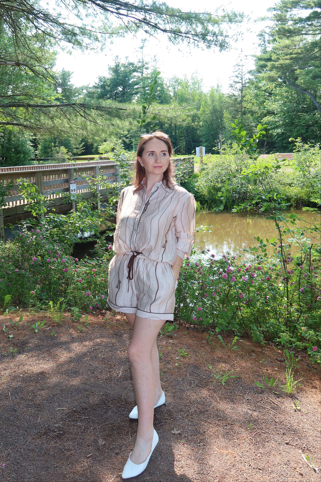Woman wearing the Portofino matching blouse and shorts set in taupe