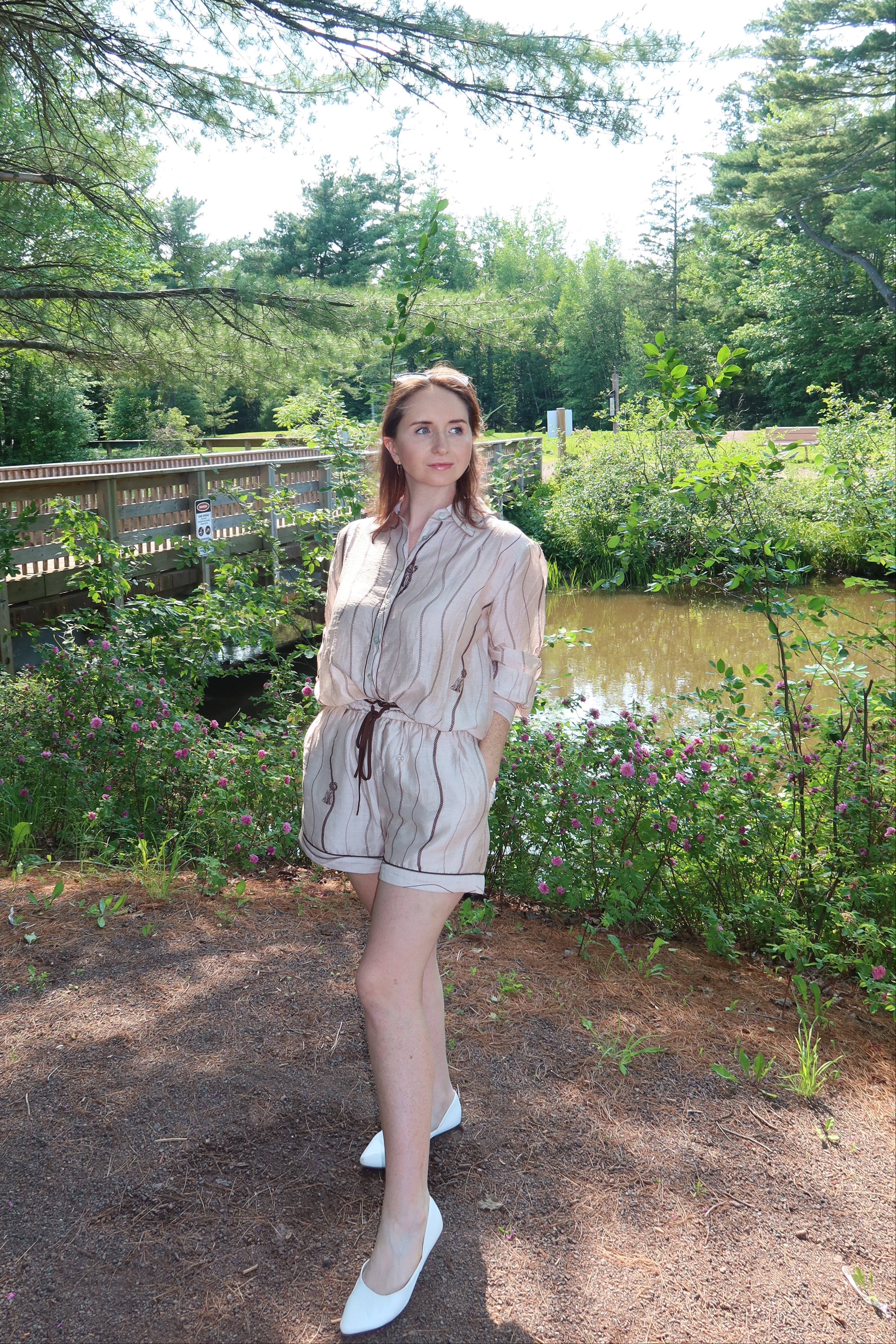 Woman wearing the Portofino matching blouse and shorts set in taupe